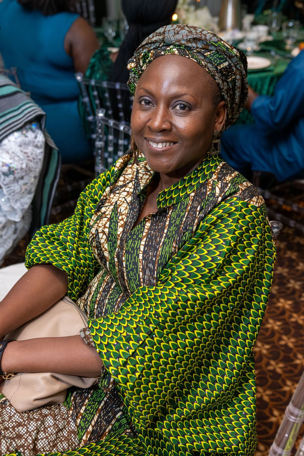 Person wearing vibrant green and yellow patterned traditional African attire smiles warmly in sequence of photos.