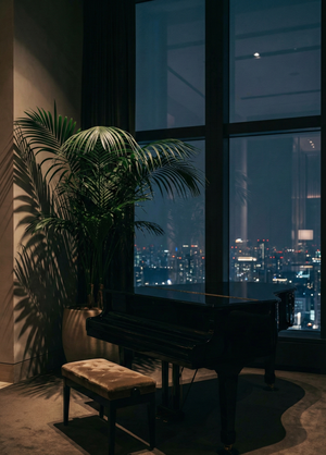 Photo of a loft in a luxury hotel of a piano overlooking a city skyline