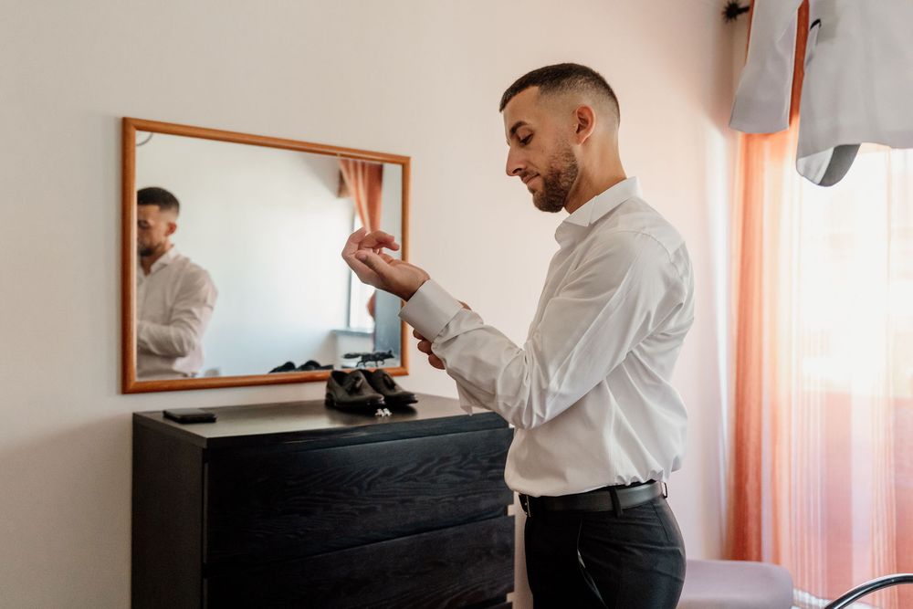 Professional in white shirt plays piano while recording music in home studio setting.