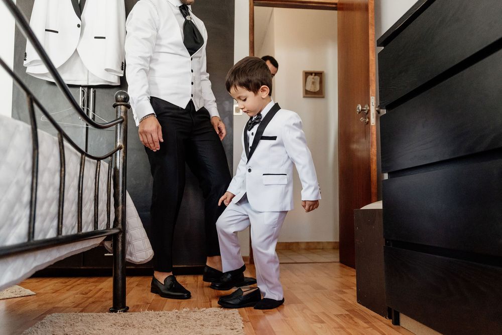 A group in white lab coats walks up a staircase in sequence during what appears to be a professional photoshoot.