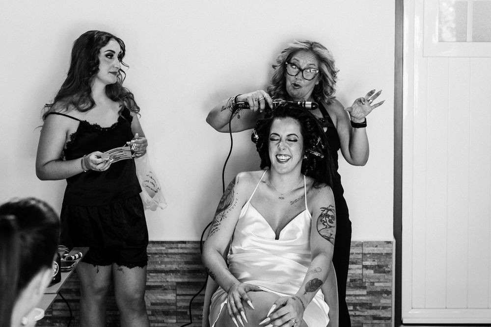 A candid black and white photo series captures joyful moments and laughter at a social gathering.