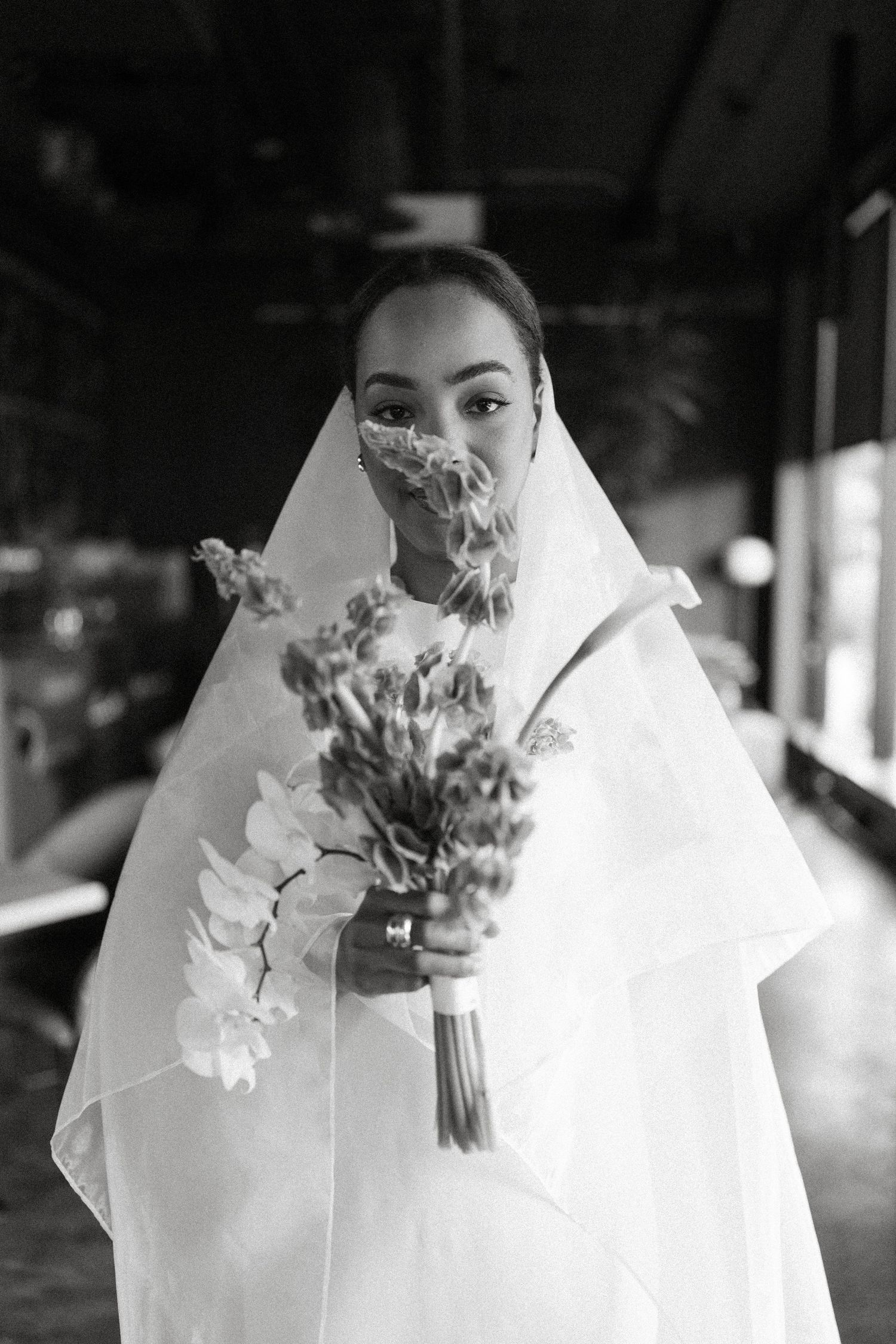 A series of black and white photos showing a bride holding a wedding bouquet in different poses.