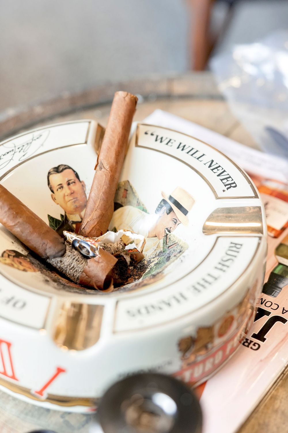 Close-up of vintage cigar ashtrays with burnt cigars.