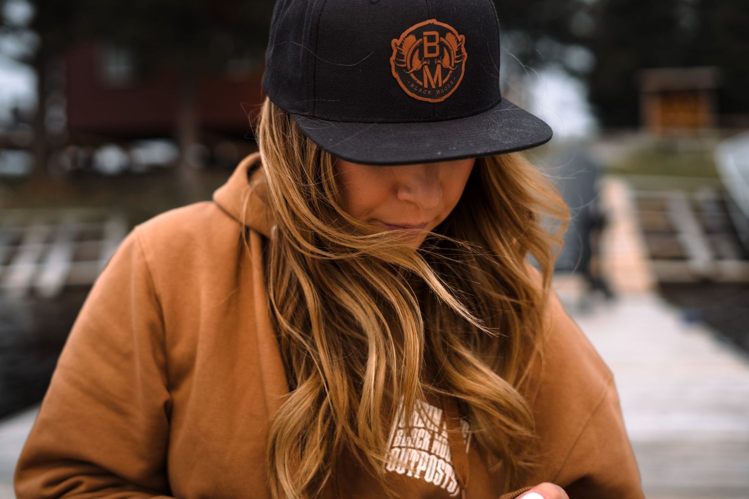 Person wearing a brown baseball cap in warm autumn lighting.