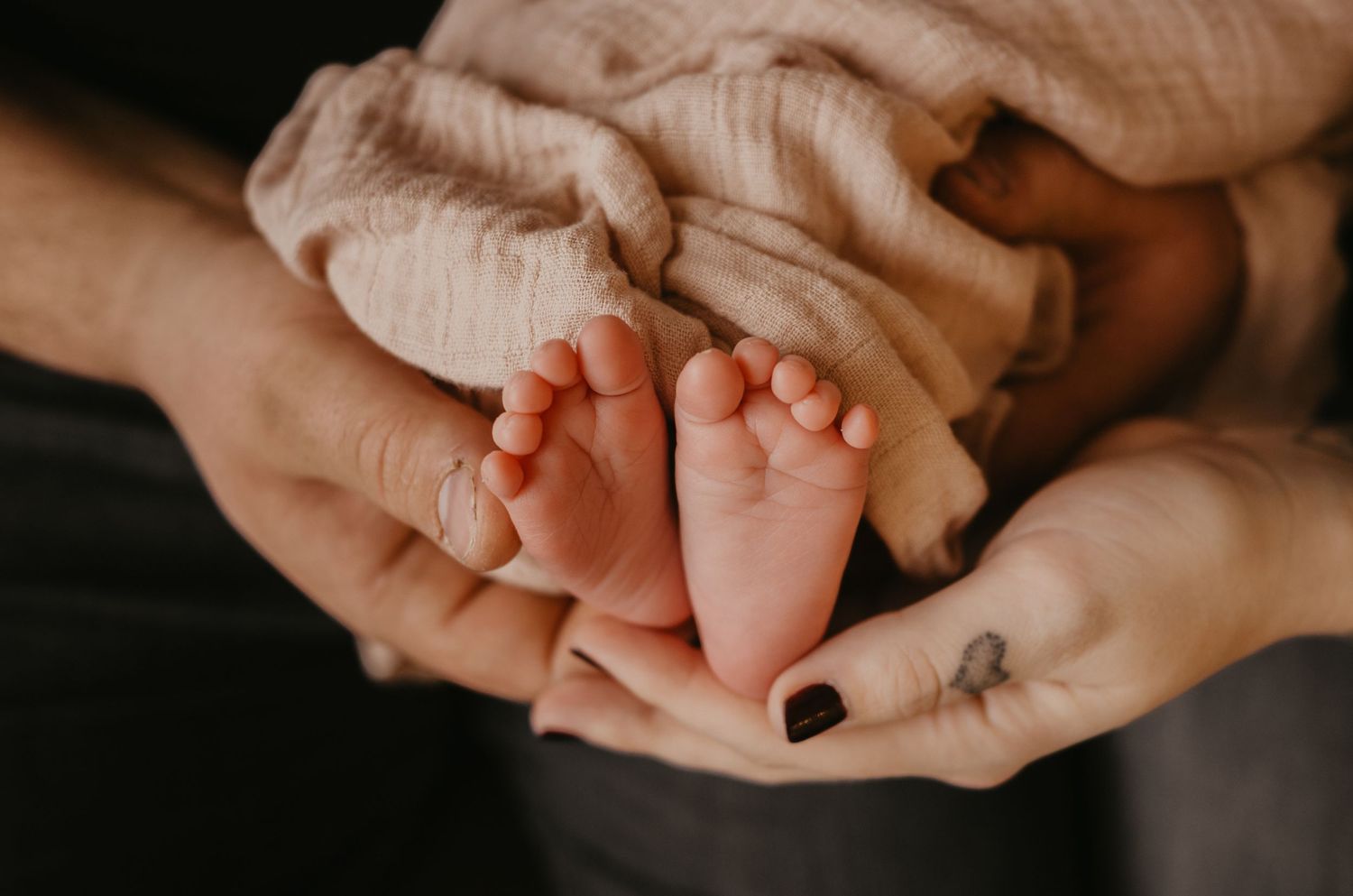 Close-up shots of hands holding and comforting each other in a sequence of tender moments.