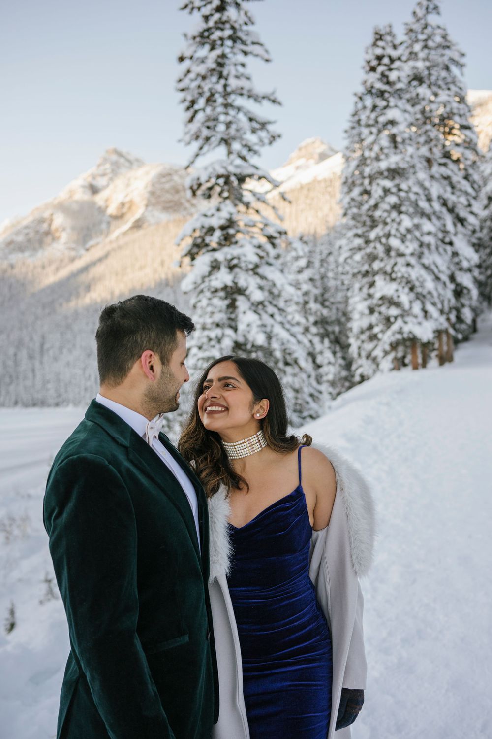 Frozen Lake Louise and Fairmont Chateau Lake Louise winter landscape with couple in foreground