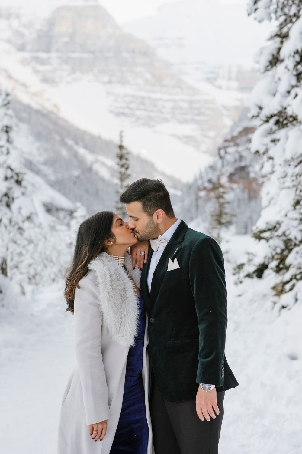 Frozen Lake Louise and Fairmont Chateau Lake Louise winter landscape with couple in foreground