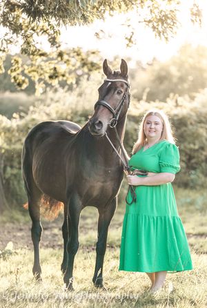 A series of photos showing a woman in a green dress posing with a beautiful black horse in a sunlit meadow.