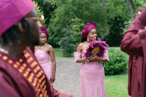 Wedding party members in pink and burgundy attire celebrating outdoors.
