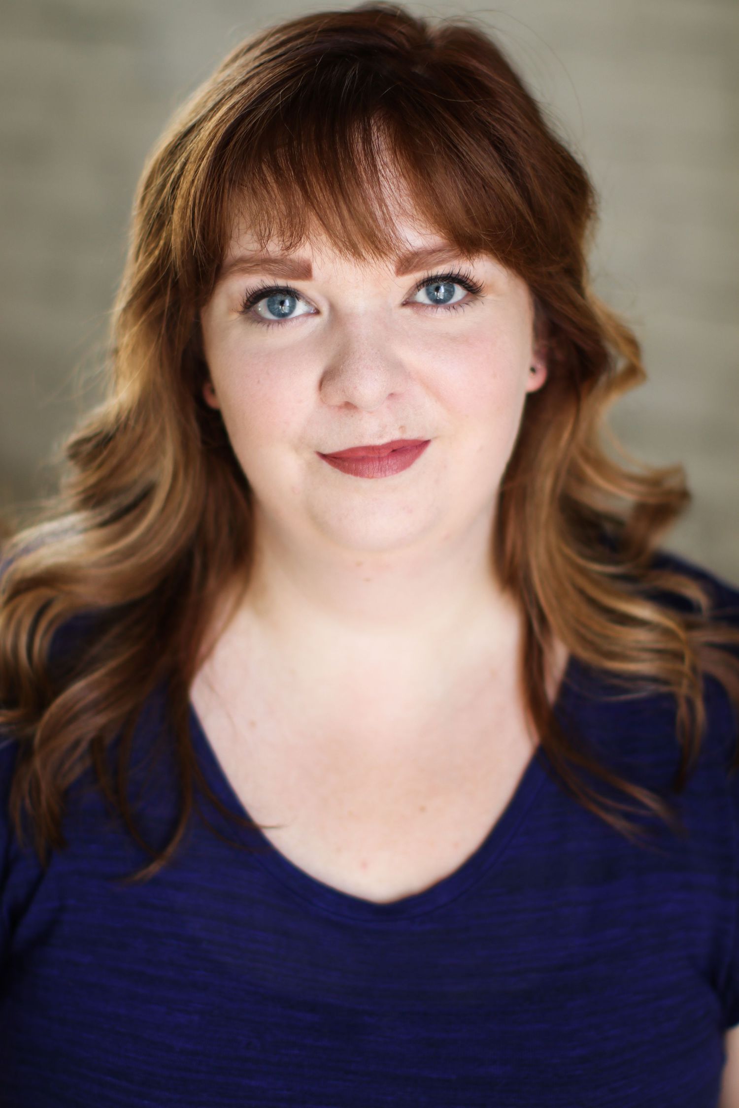 Professional headshot series in navy blue top against neutral background. Headshot photography.