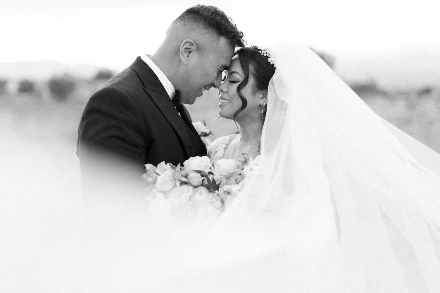 Black and white romantic wedding portrait with flowing veil.