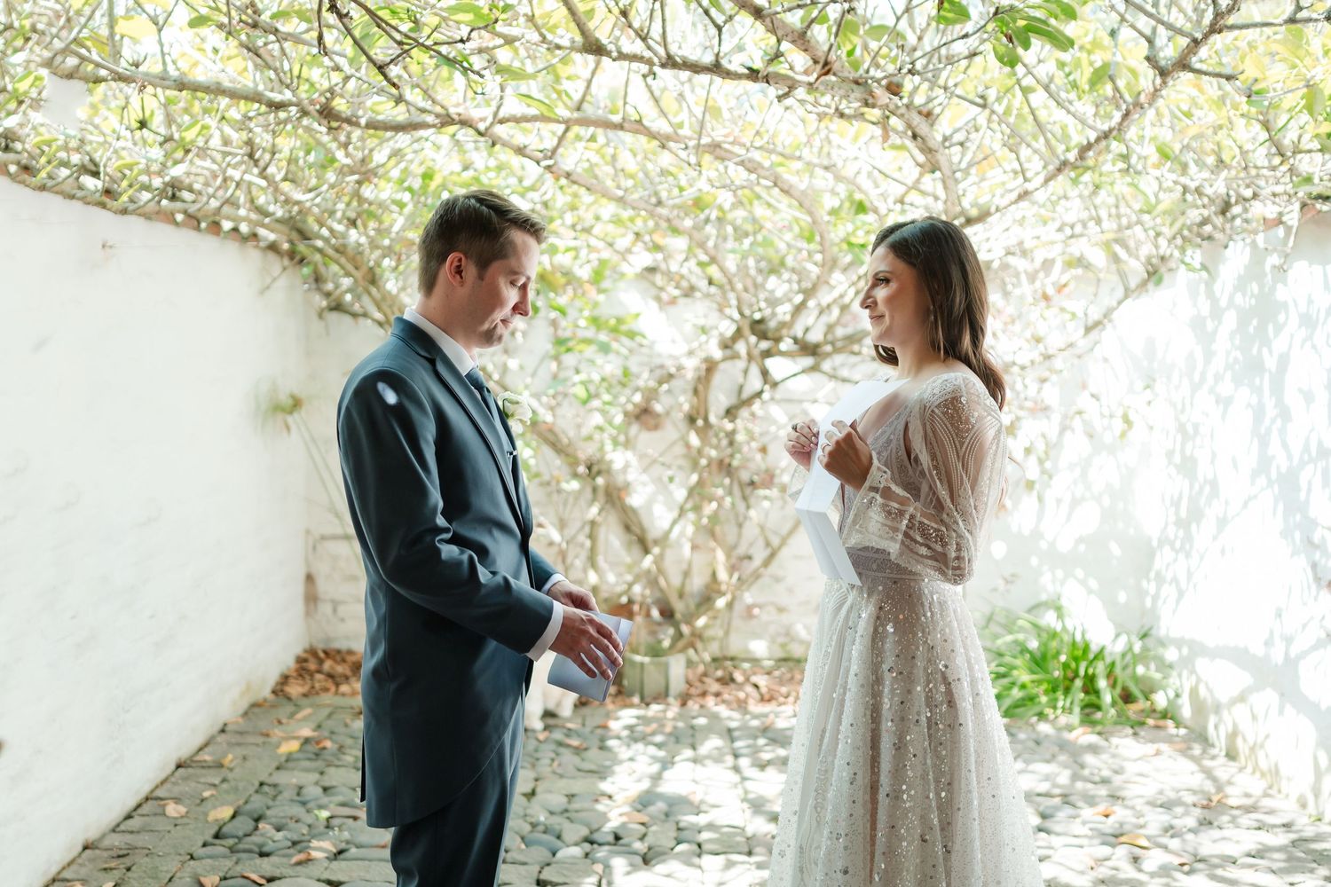 Romantic moment captured under blooming spring trees in a garden setting.