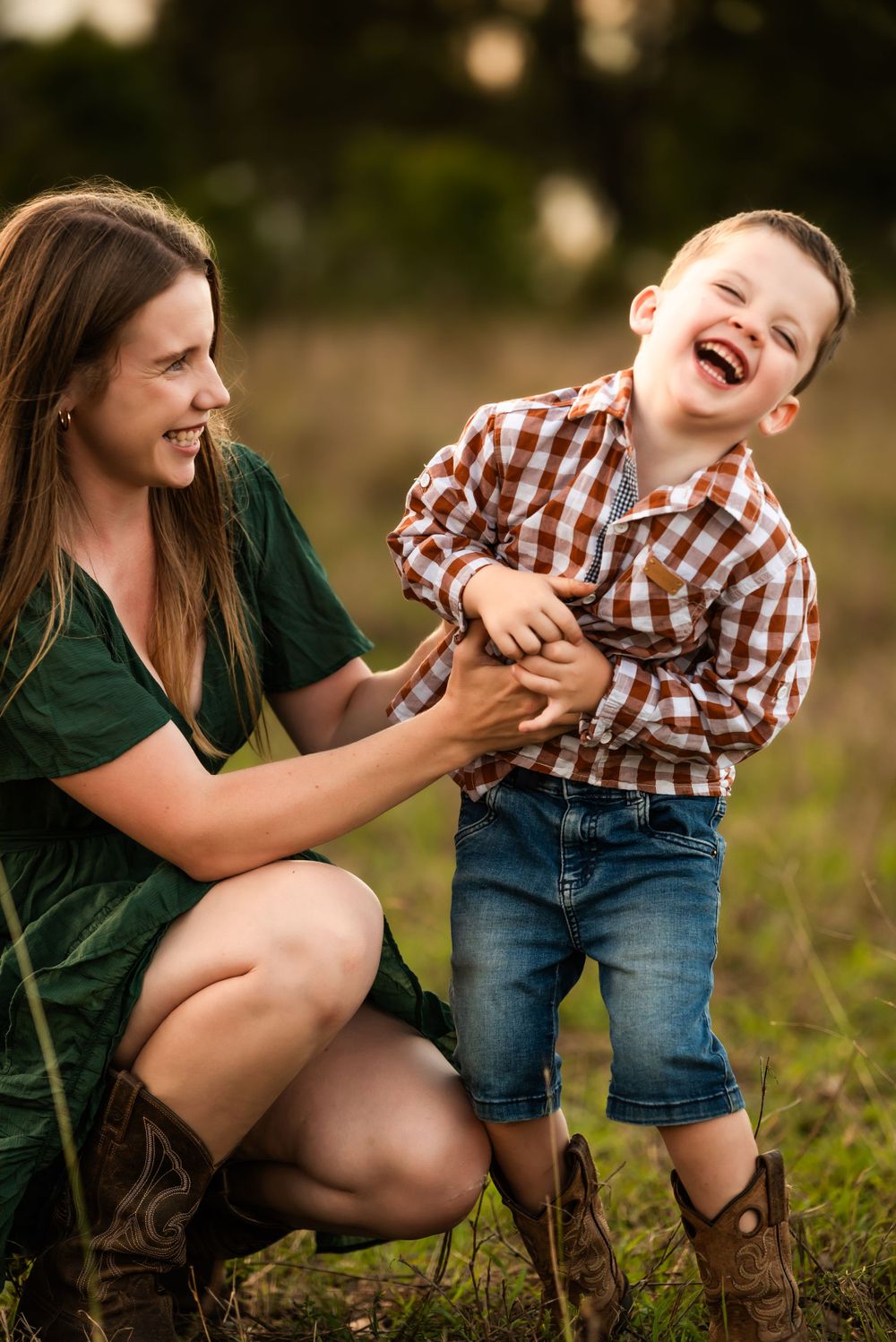 Candid moment of laughter and joy captured in outdoor portrait session.