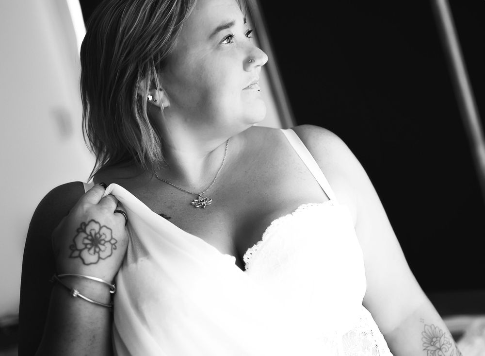 Side lit natural light pose using fabric to create flowing contrast within the image.