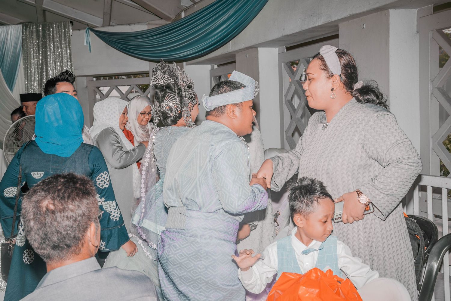 Guests mingling and interacting at a formal celebration event.