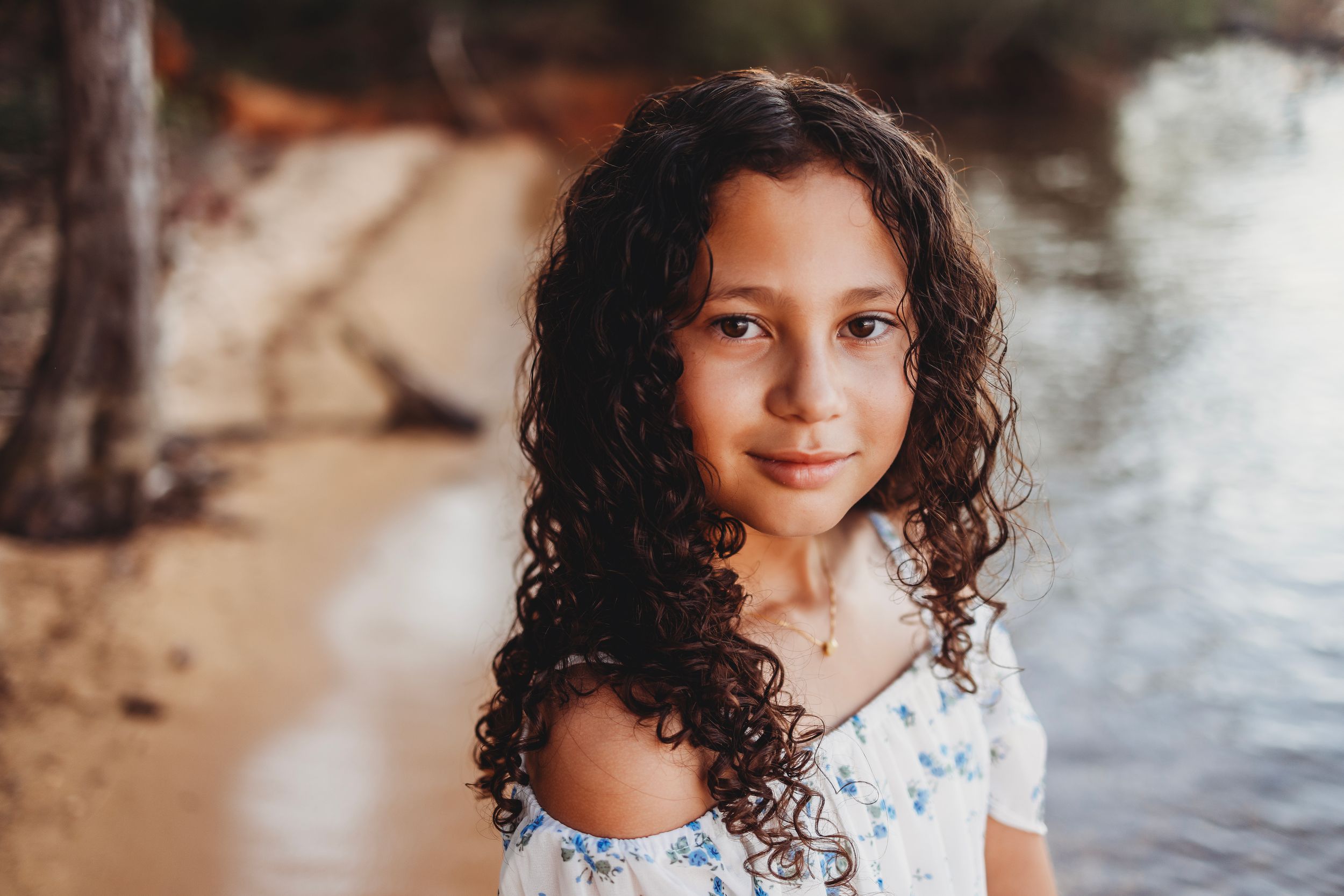 Close-up portrait showing natural curls and gentle expression.