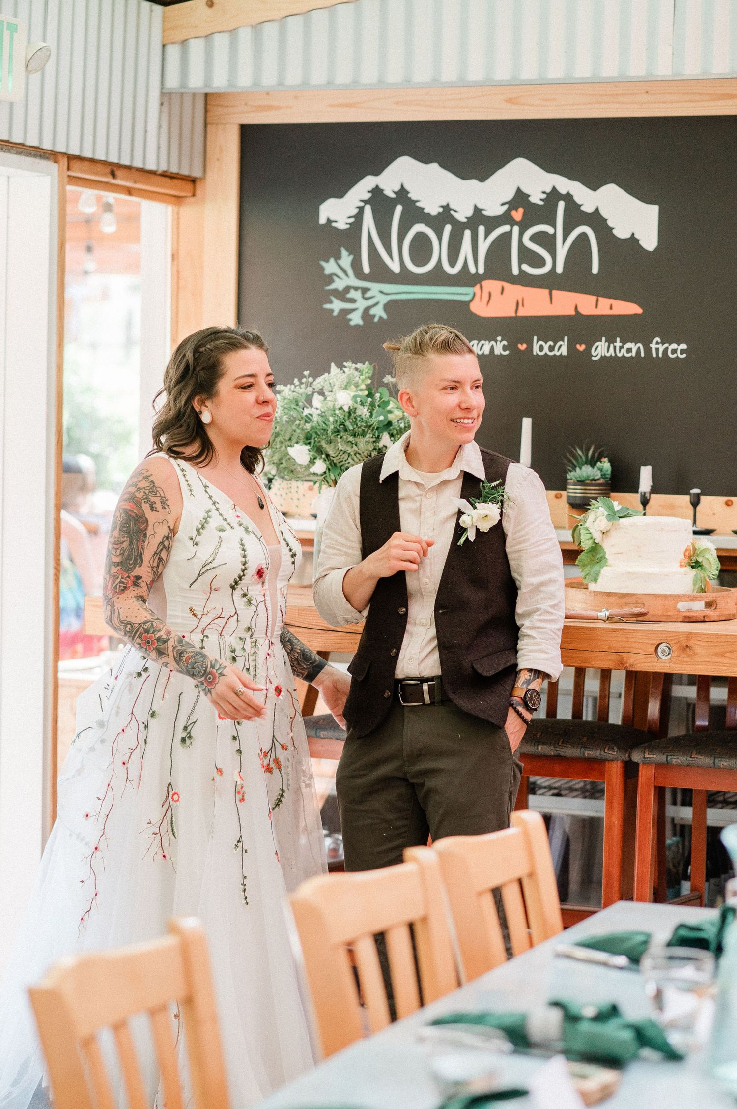 Couple sharing a candid moment of laughter while seated at wooden tables in a restaurant called Nourish in Sequim, Washington