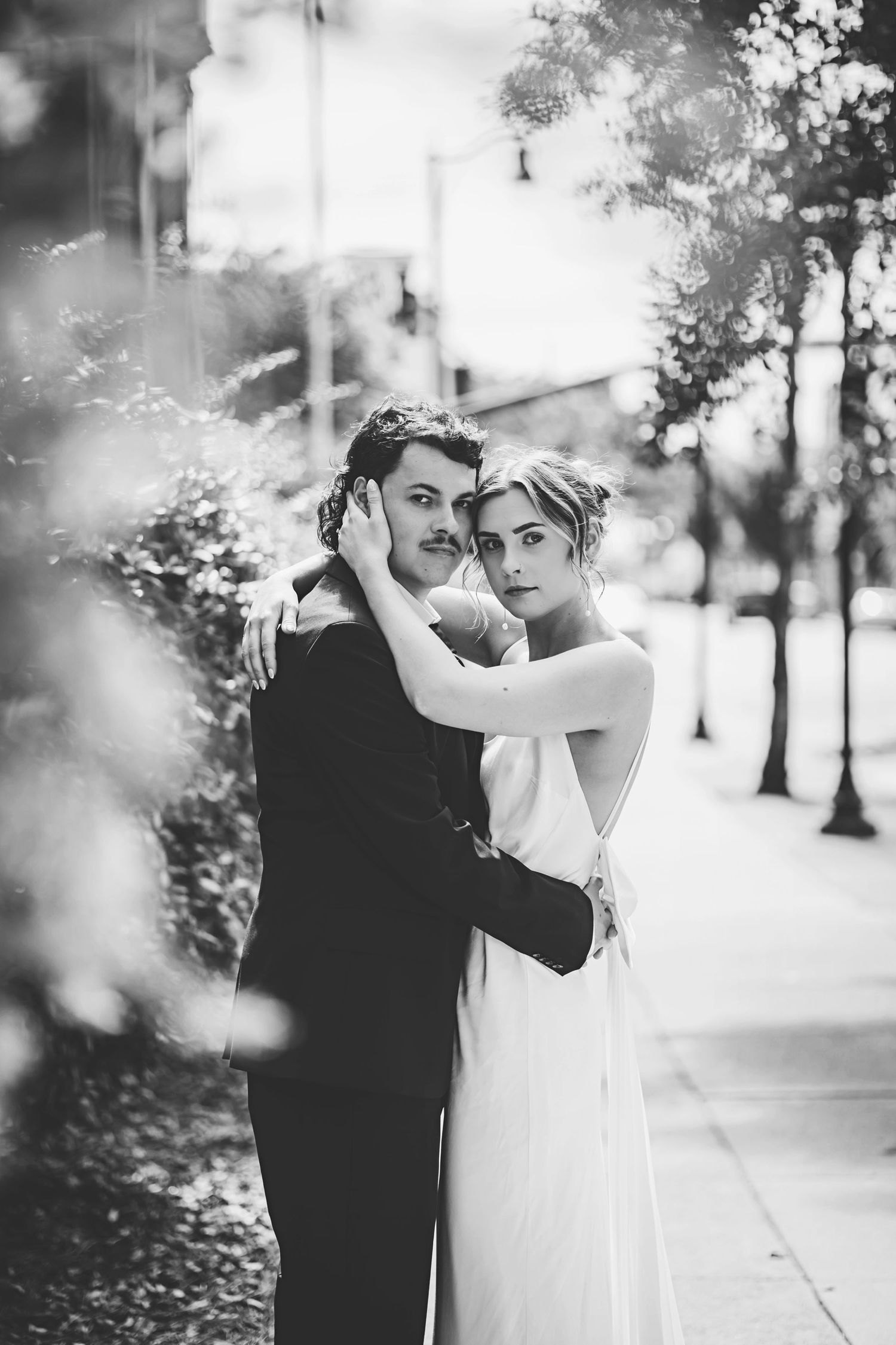 Romantic black and white wedding photography sequence showing tender intimate moments between bride and groom in nature.