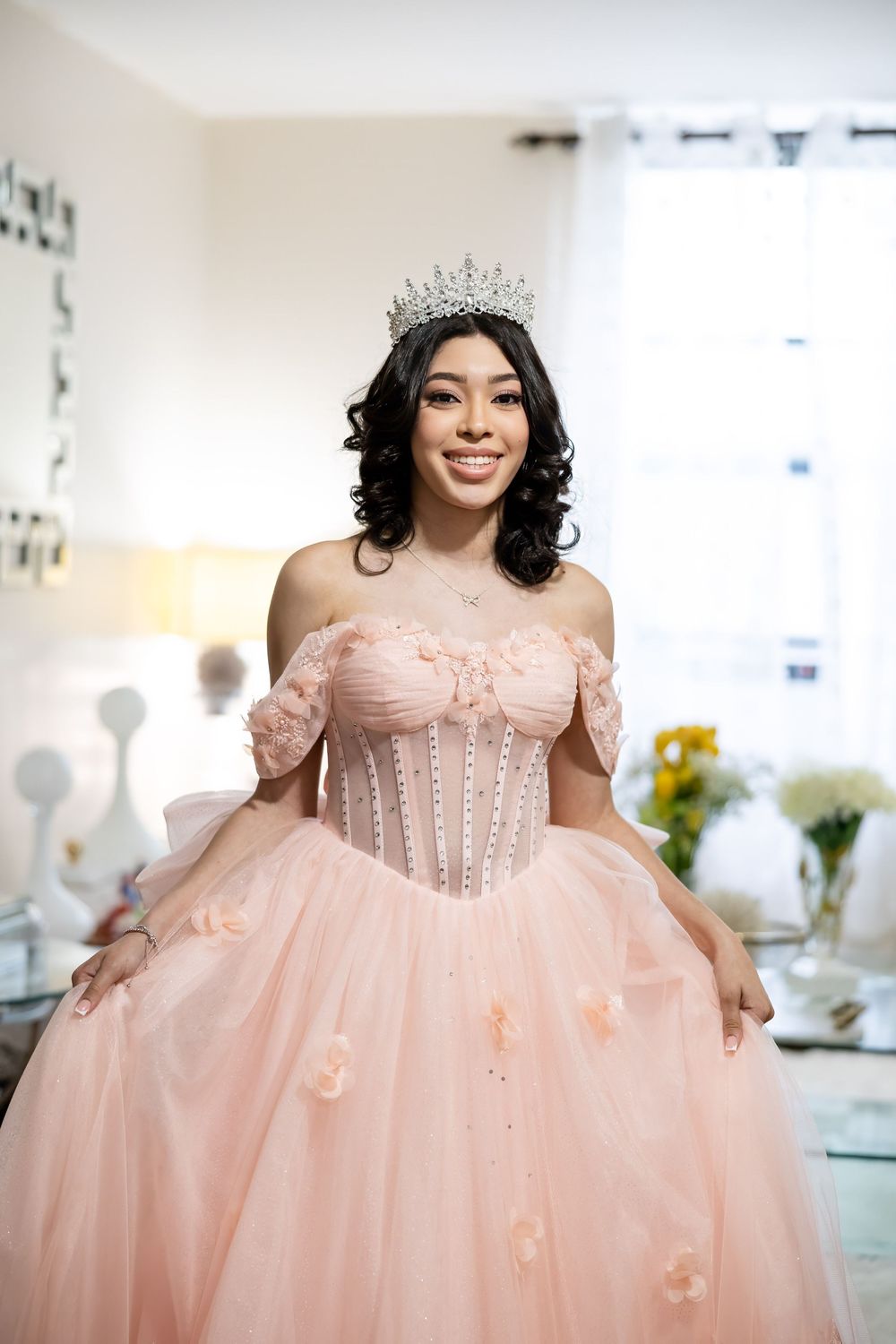 Princess-style pink gown with corseted bodice and full tulle skirt indoors.