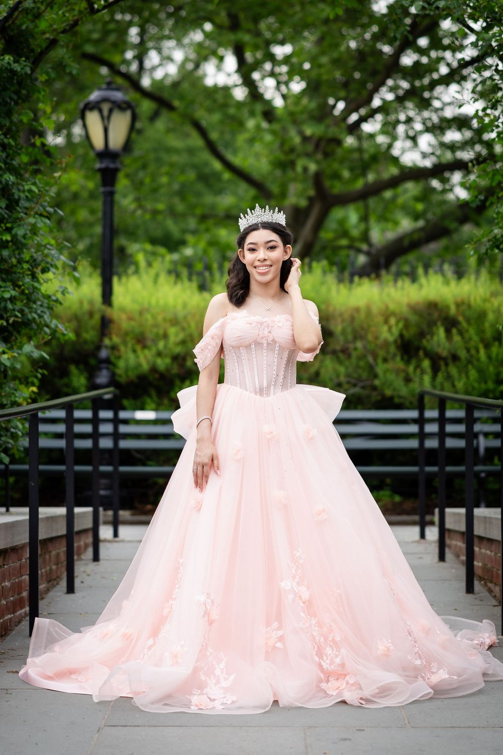 Elegant full-length portrait on garden path wearing blush pink princess gown.