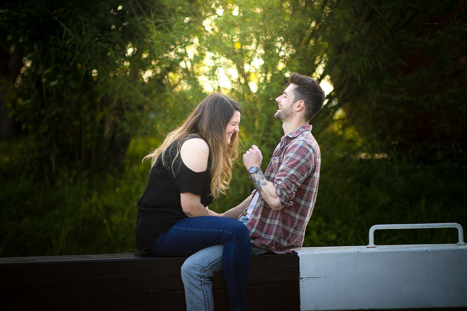 Couple enjoying a romantic moment together in a lush garden setting at golden hour.