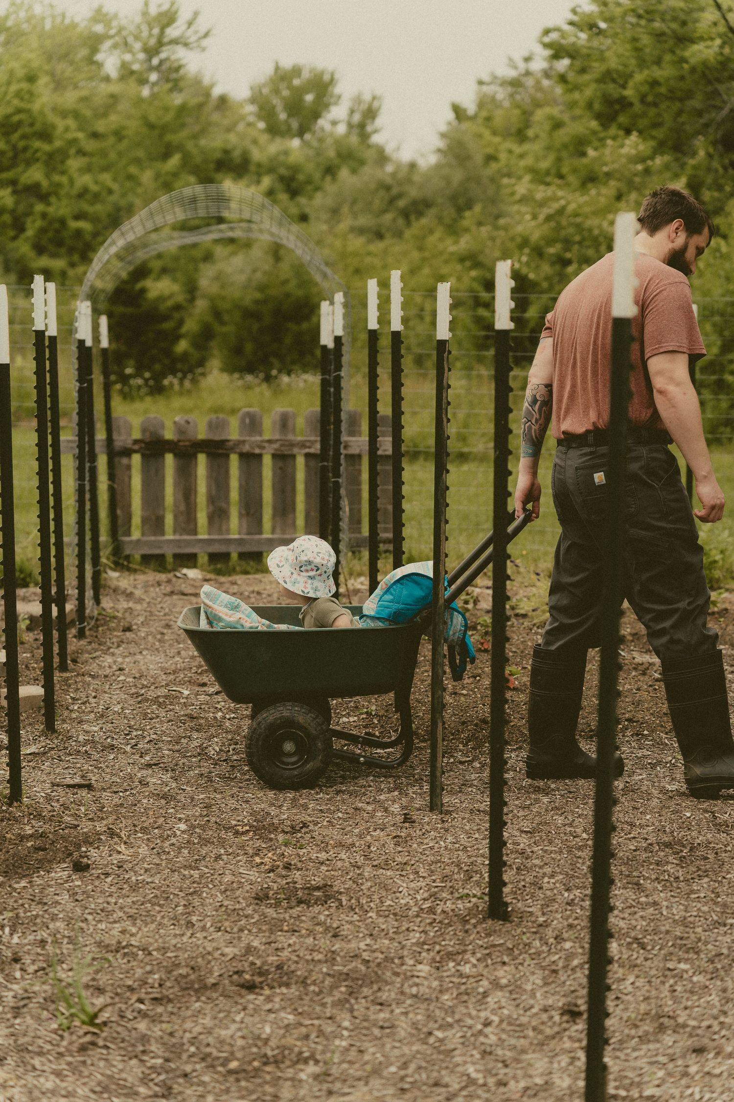 Person pulling a child in a wagon in the garden during a family photo session in Centerville Ohio.