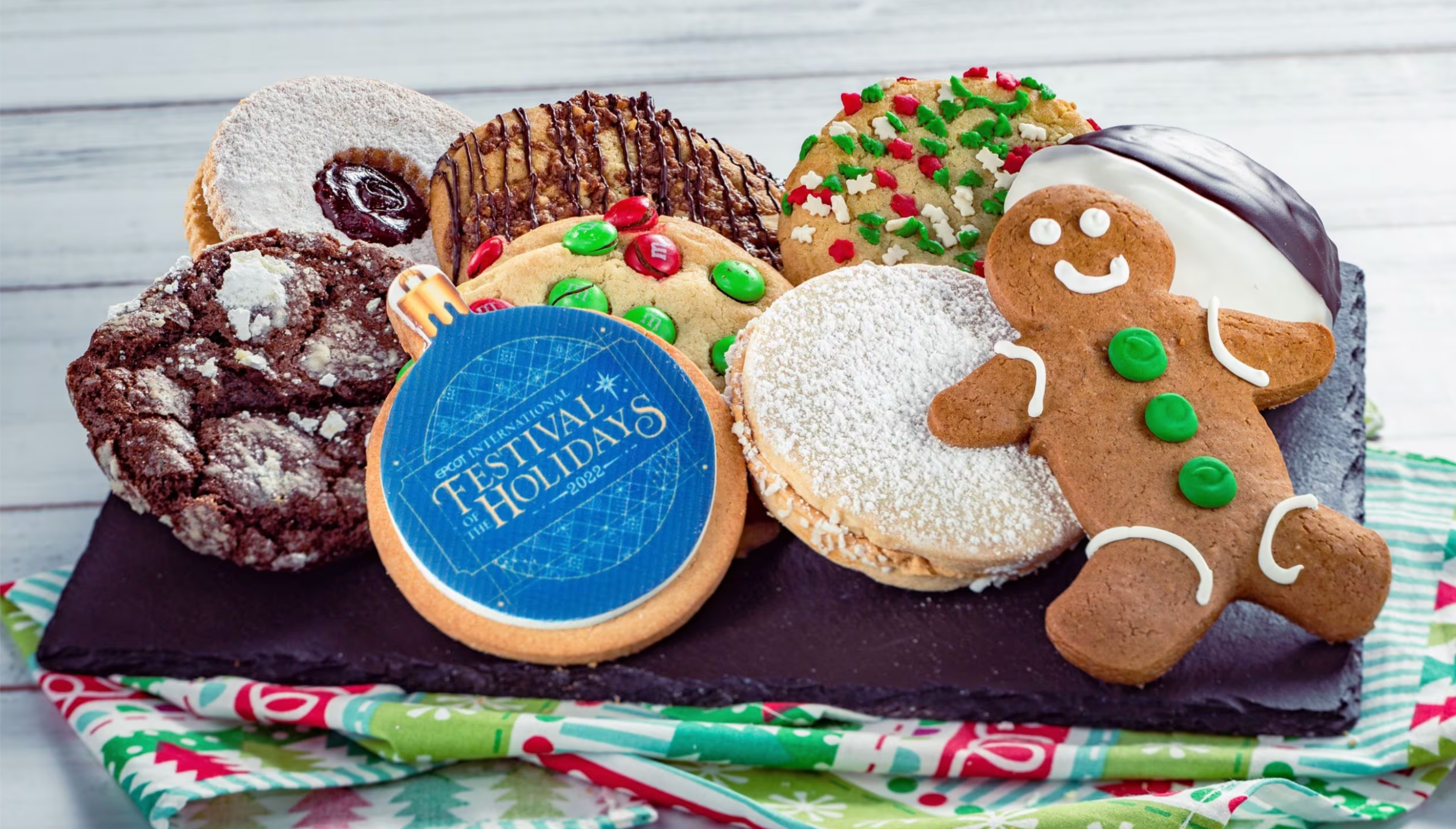 Assorted Christmas cookies and treats decorated with frosting and candies on a white surface.