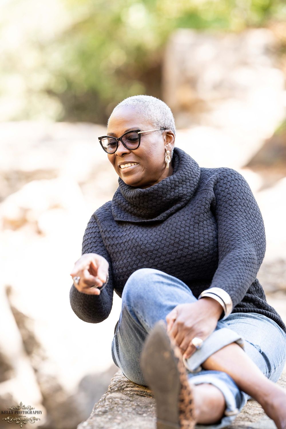 Cozy winter fashion featuring chunky knit turtleneck sweater and distressed jeans in outdoor setting.