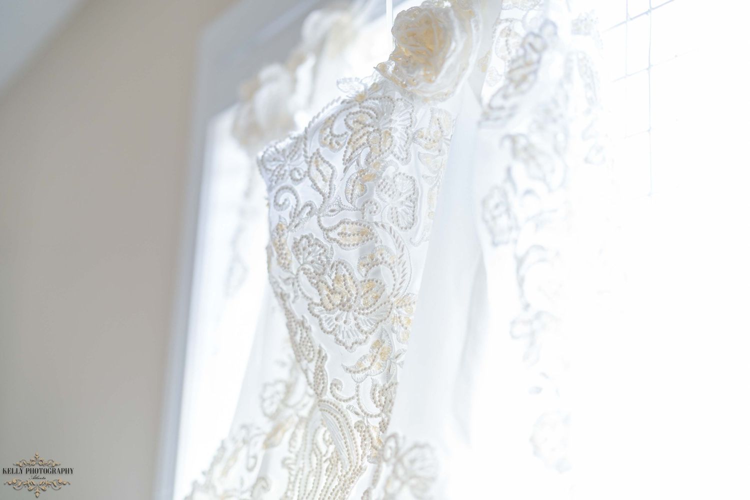 Intricate lace detail of a wedding dress photographed against natural light.
