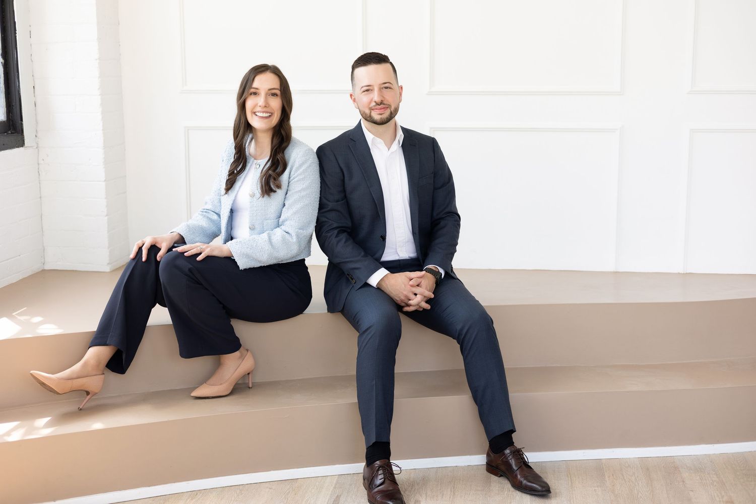 Real Estate couple wearing navy's and pastel blues for their headshot photography session in London Ontario.