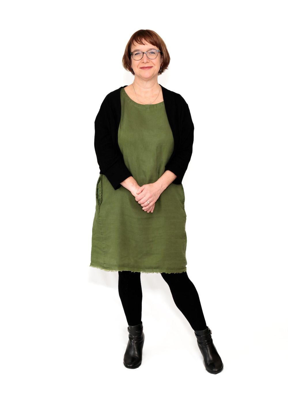 Full length professional portrait of business woman standing in front of white back drop