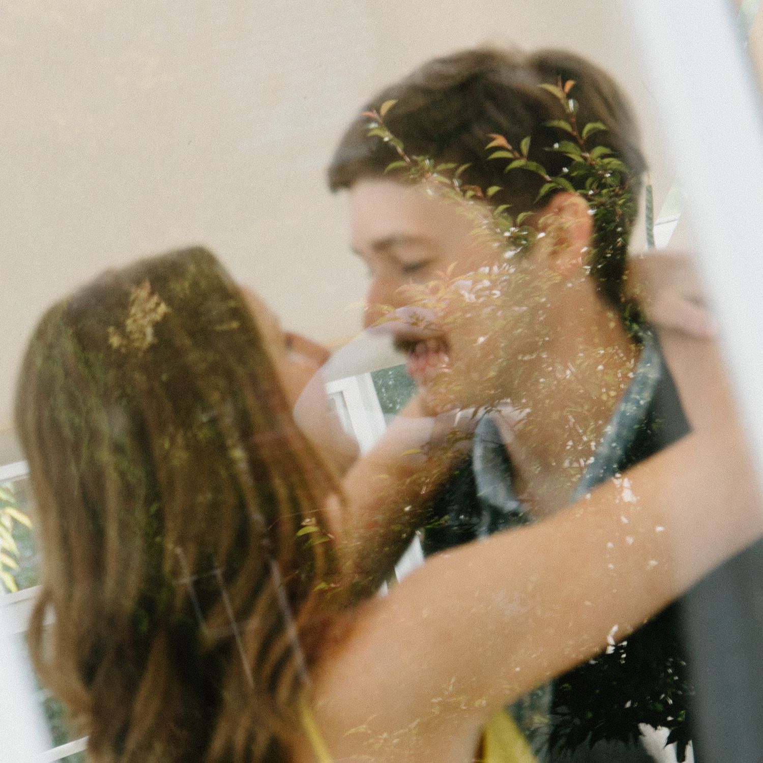Someone tossing glitter and confetti in a celebratory motion against a light background.