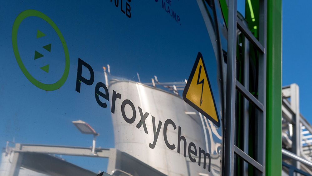 Close-up of PeroxyChem company signage with warning symbol on industrial equipment.