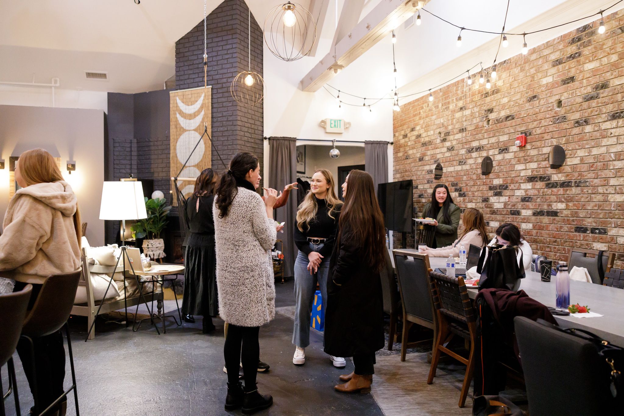 EMPW women's networking community in Puyallup, WA group of women standing talking and laughing connecting together