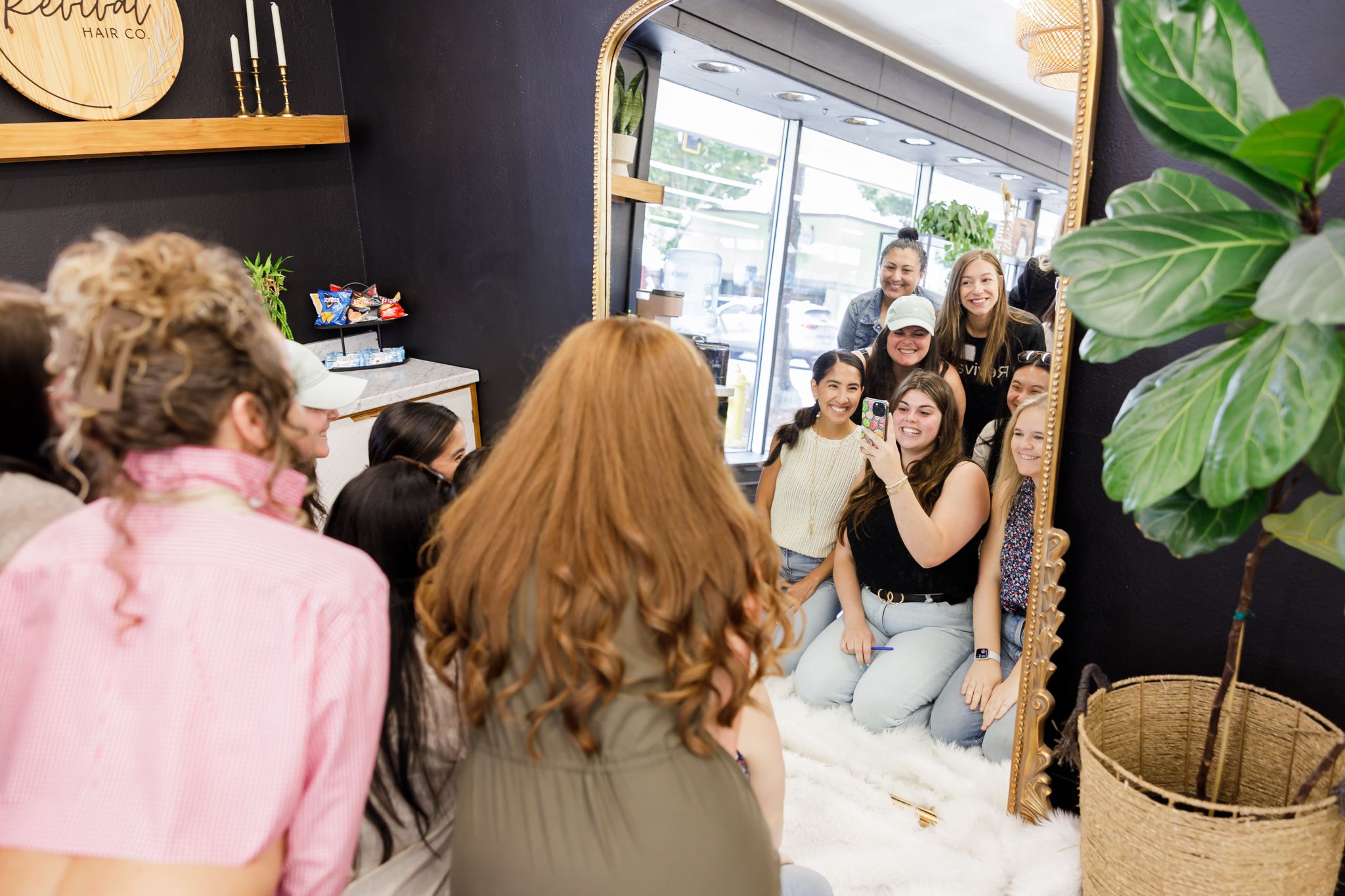 ENMPW women's networking community in Puyallup, WA women sitting in front of large mirror creating group content for Instagram reel post