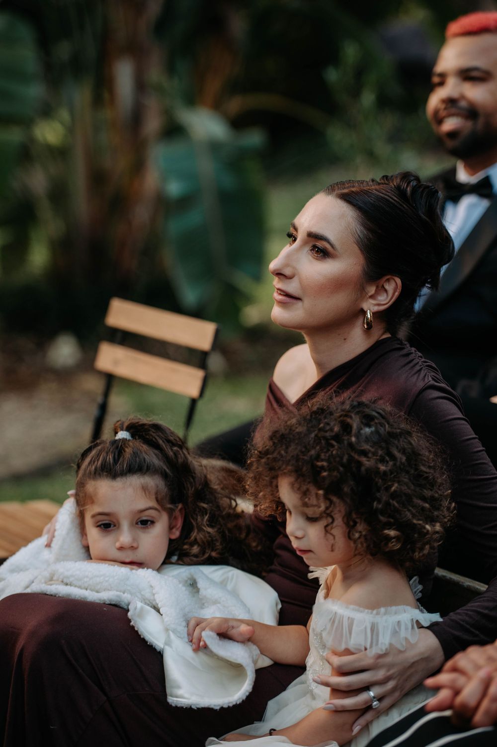 A series of candid wedding moments showing guests sharing tender moments during an emotional outdoor ceremony.