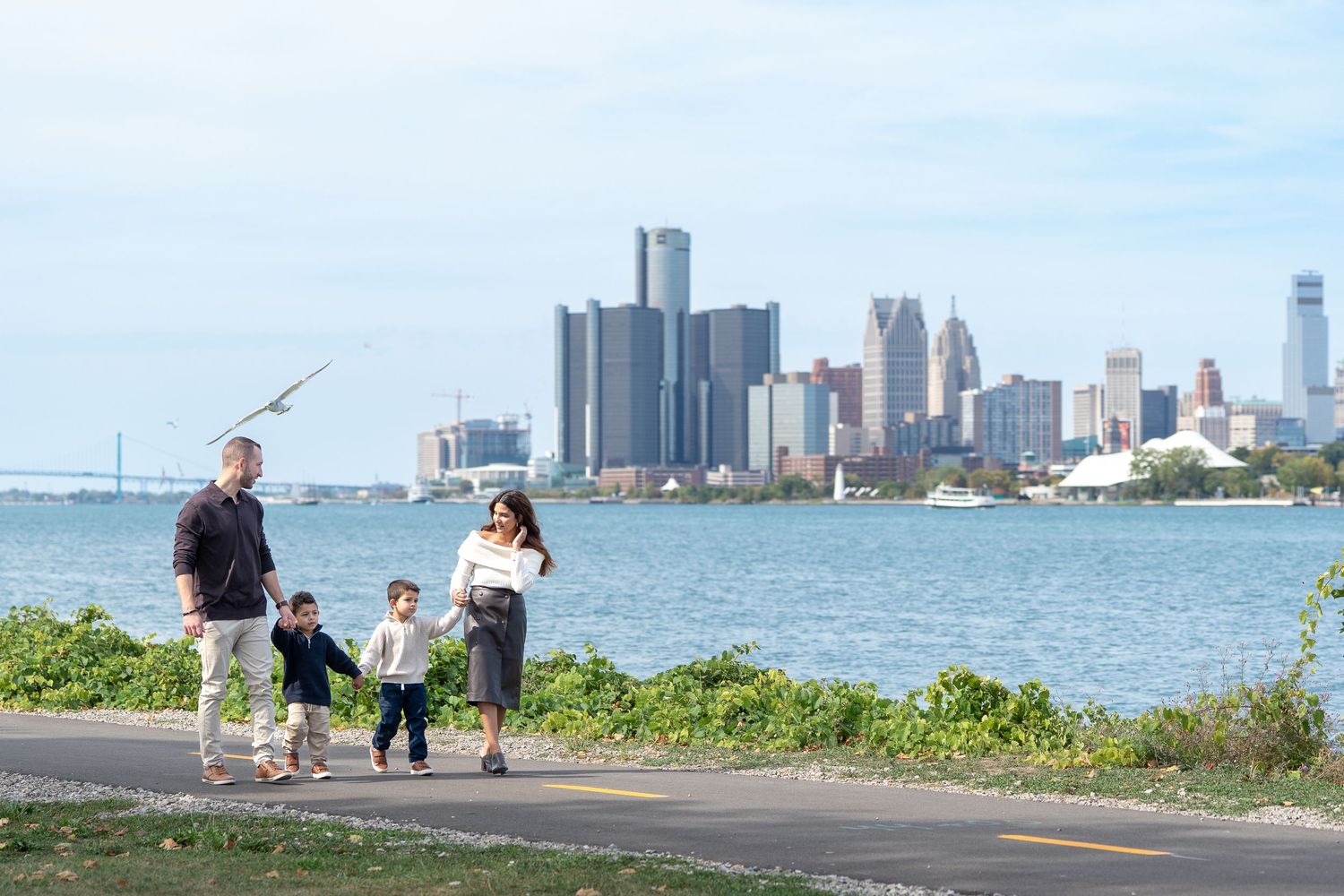 People enjoying a sunny day along Lake Michigan with the Chicago skyline visible in the background.