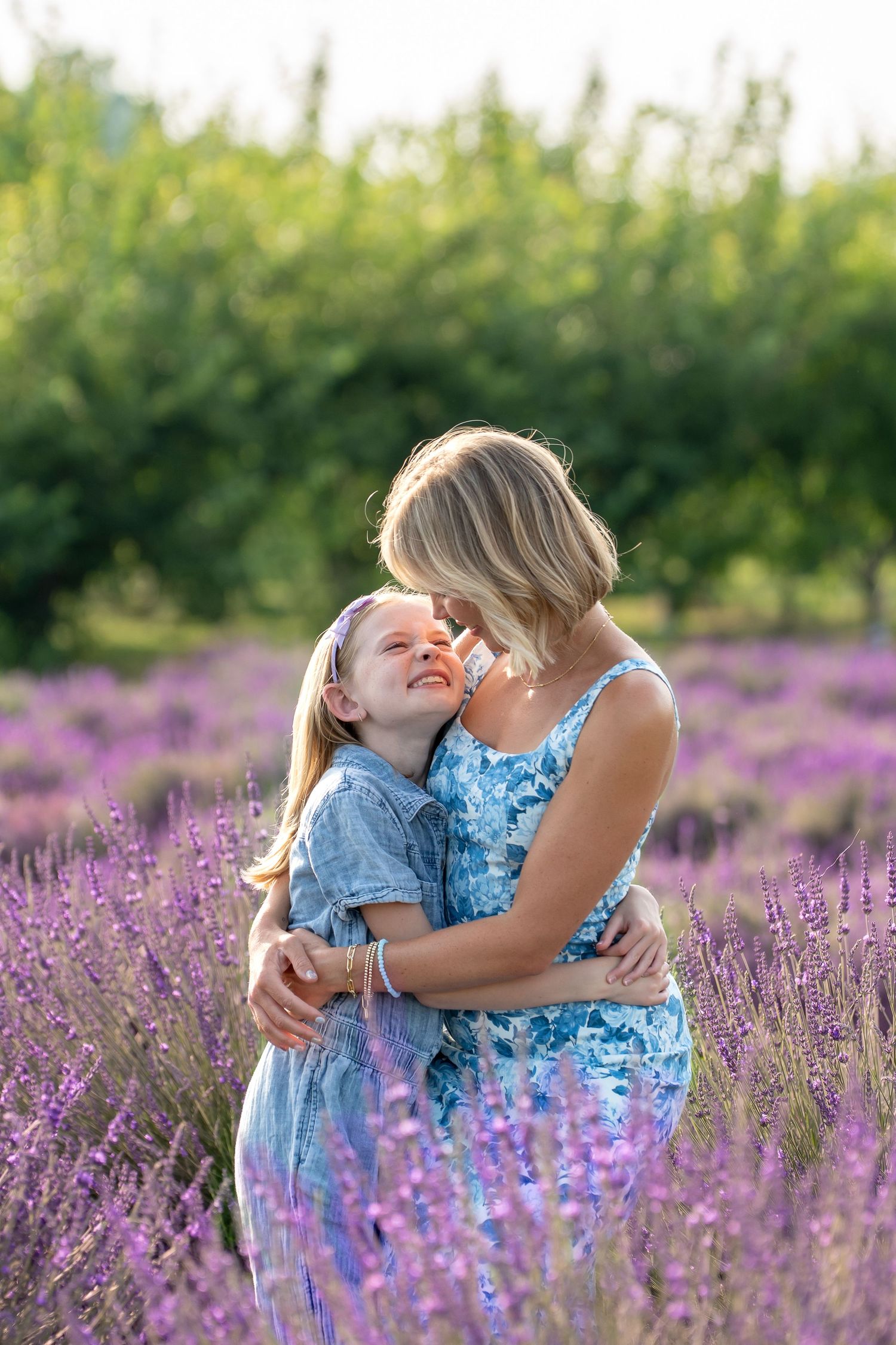 A tender moment shared between two people embracing in a beautiful blooming lavender field on a sunny day.