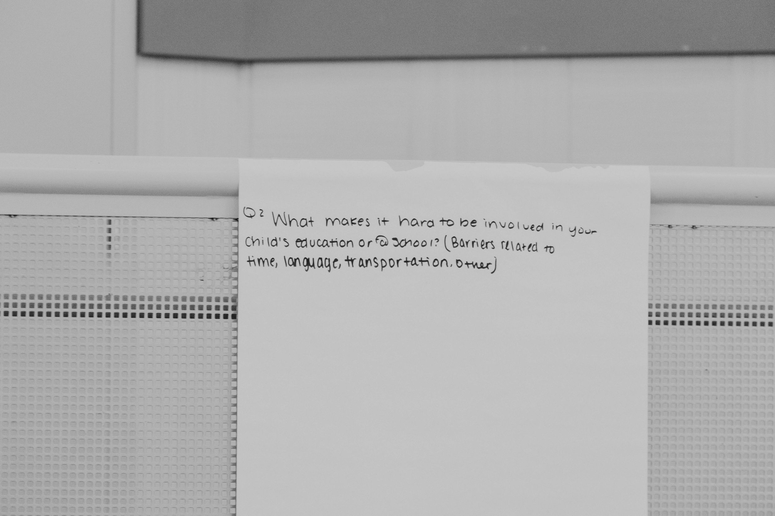 Grid paper and handwritten notes on a white desk surface.