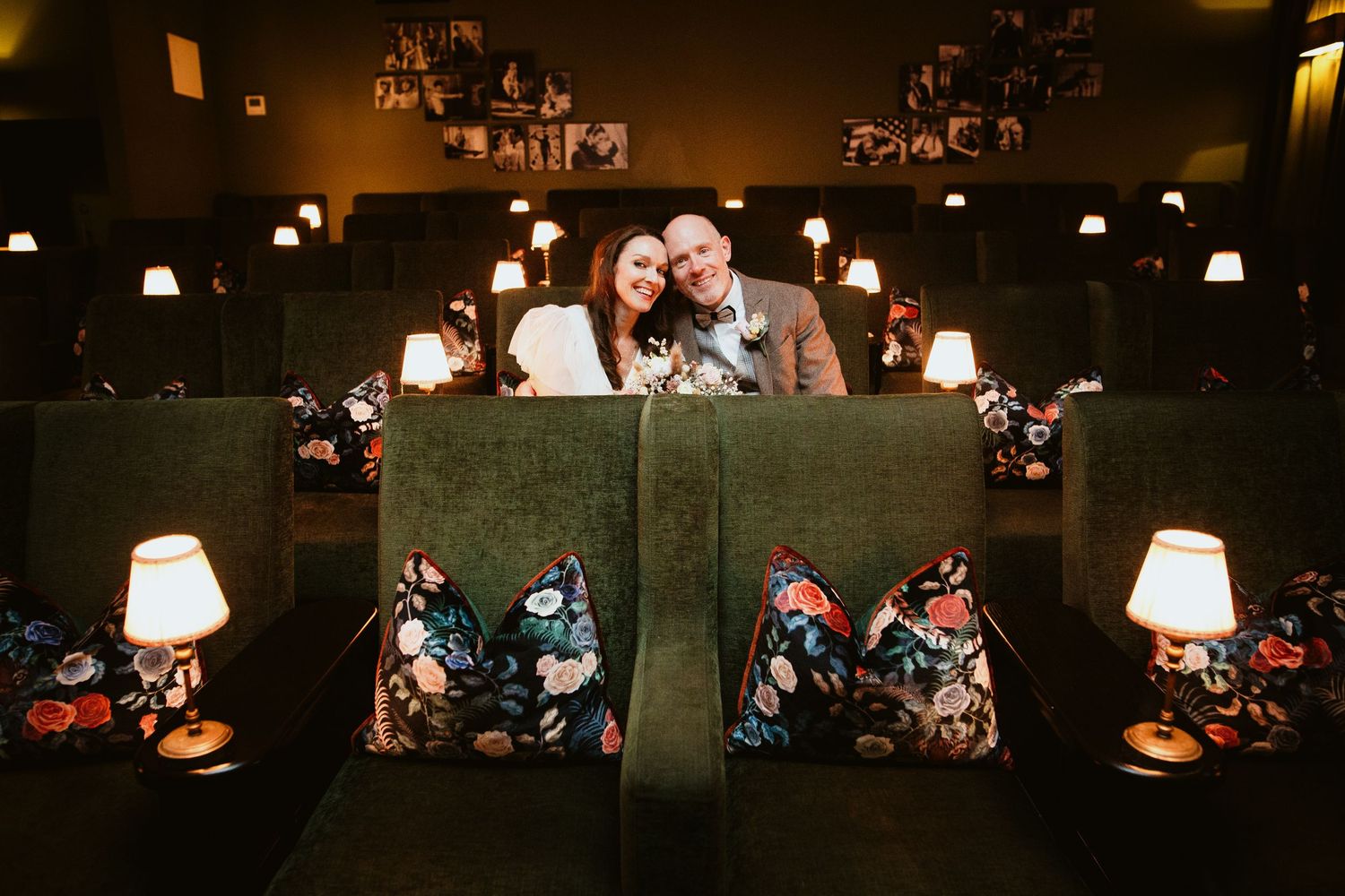 Dimly lit restaurant interior with table settings, pendant lamps, and warm ambient lighting creating an intimate atmosphere.