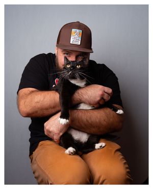 Self portrait holding my late tuxedo cat, Leia.