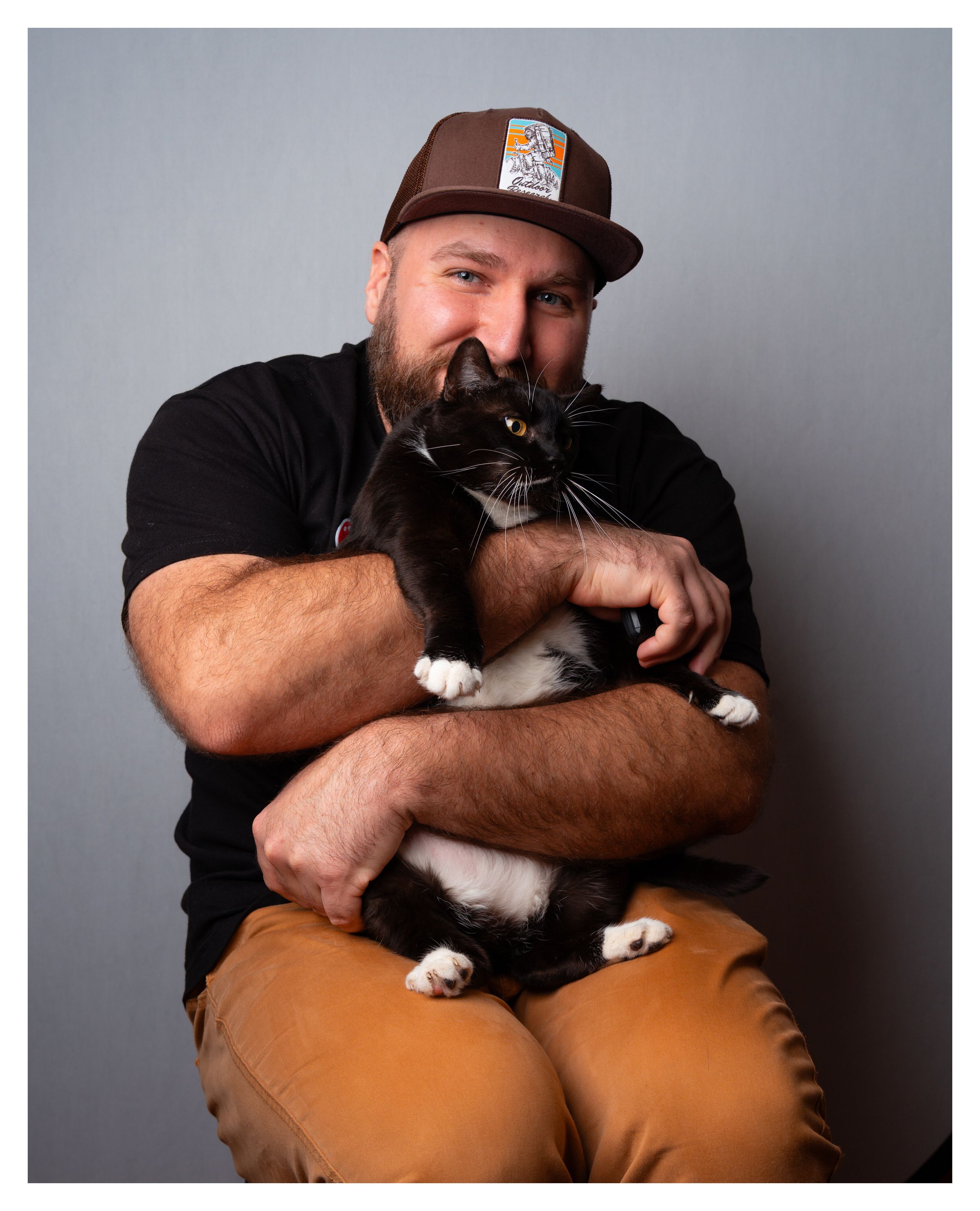 Self portrait holding my late tuxedo cat, Leia.