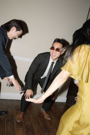 People in formal attire dancing and having fun at a party on hardwood floors.
