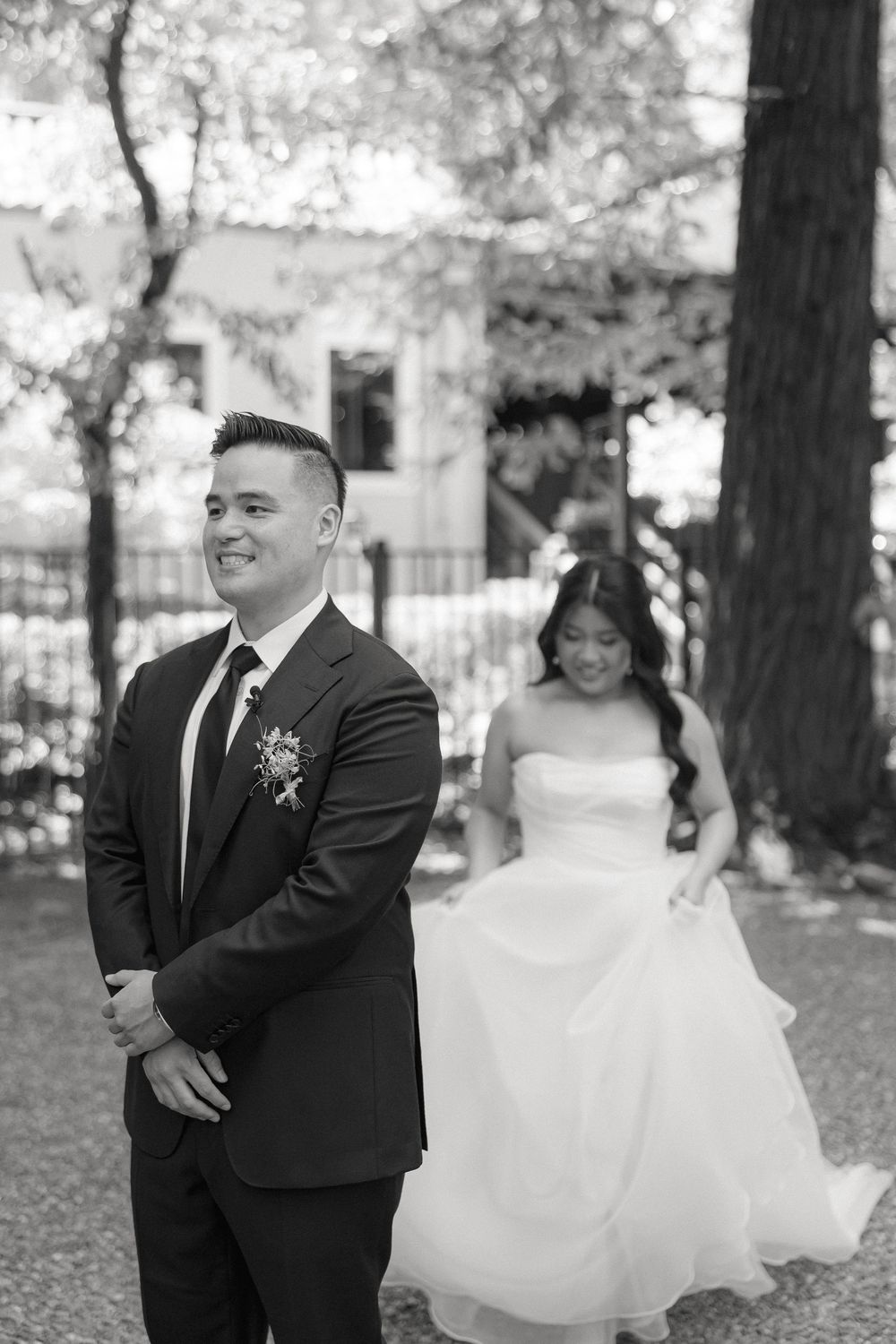 A joyful couple embraces and laughs together during an outdoor autumn wedding photo session.