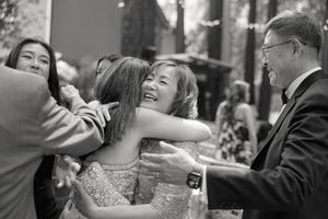 People dance and celebrate during a wedding reception on a crowded dance floor.