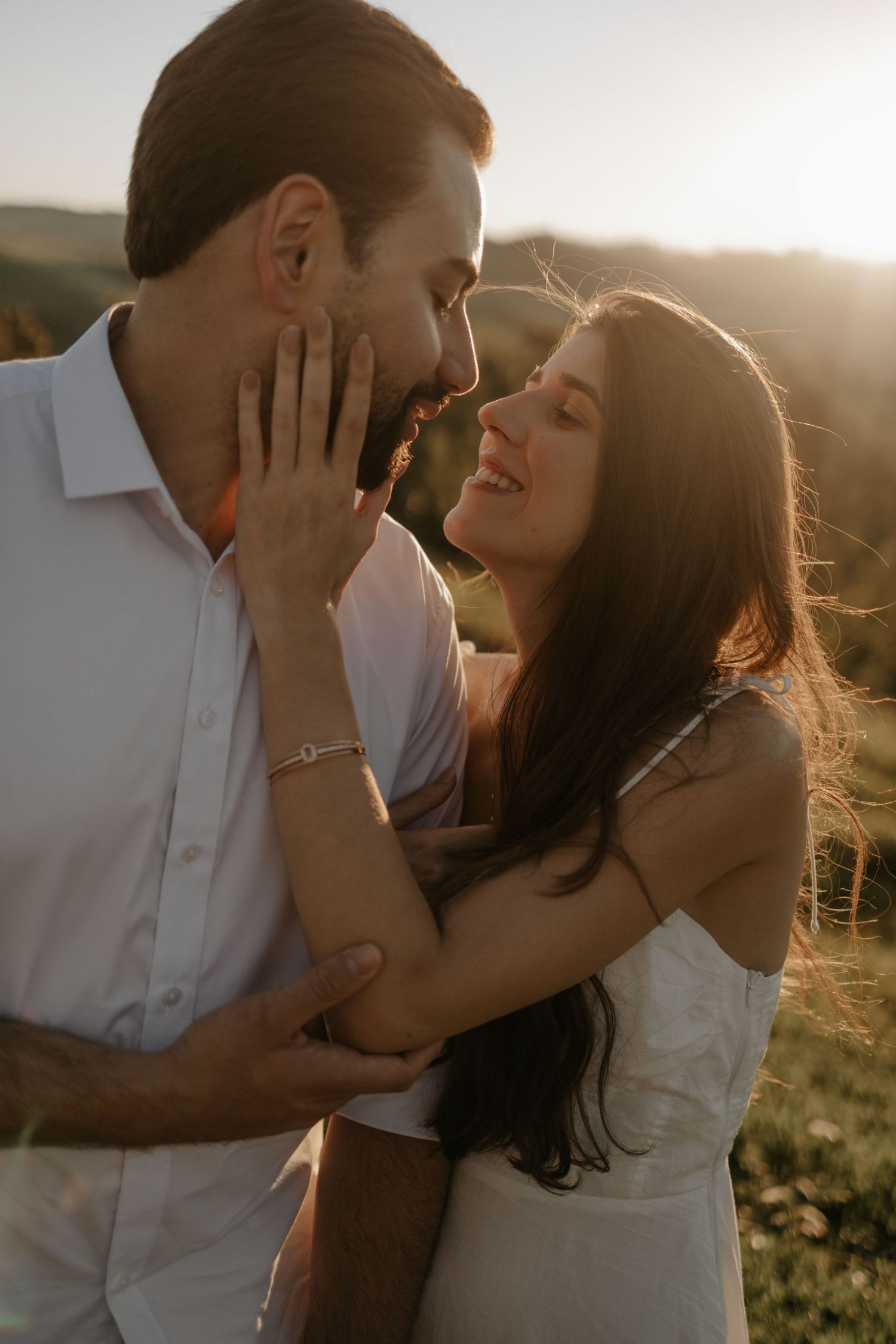 couple standing side by side during sunset at the mountains