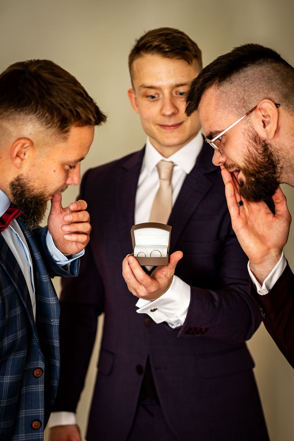 Group wearing formal attire sharing emotional moments together.