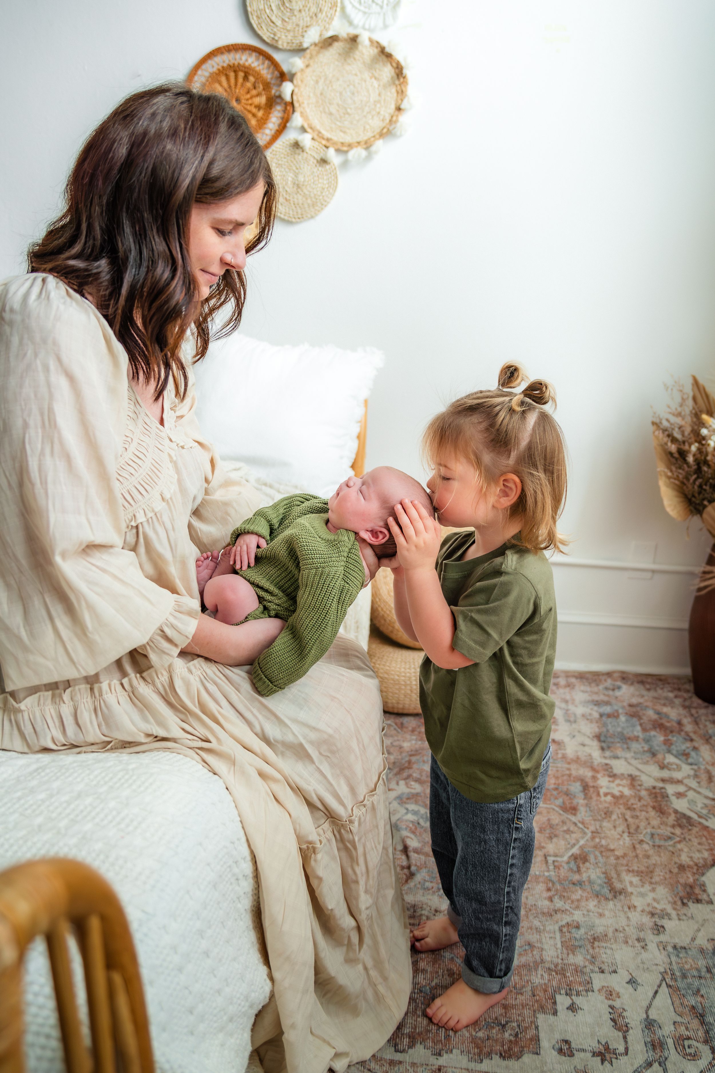 Sweet interaction between parent and child with baby on carpeted floor.