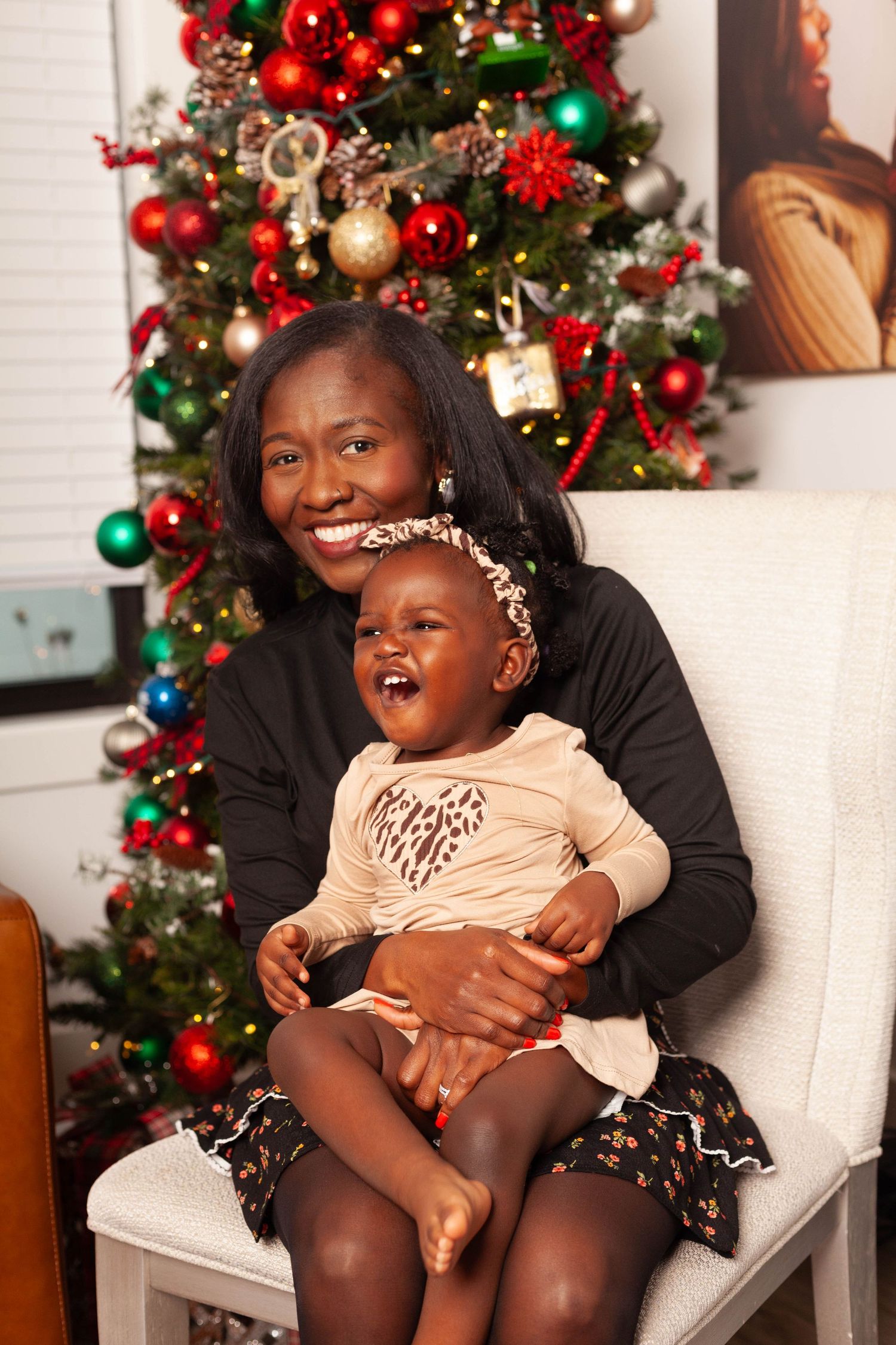 A festive holiday scene with a decorated Christmas tree featuring red and green ornaments and twinkling lights.