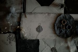 Black and white film strips showing abstract patterns and textures in a vintage photographic style.
